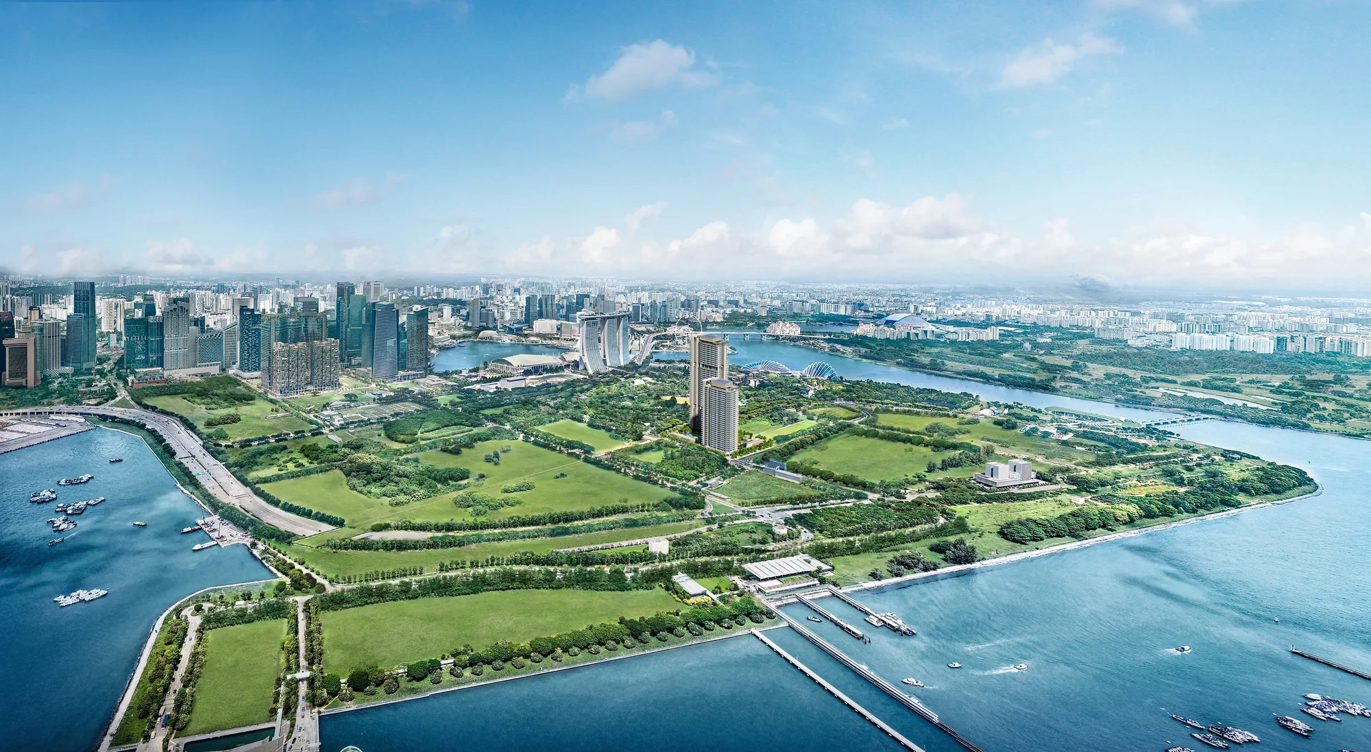 One Marina Gardens, artist&rsquo;s impression: an aerial view over the Marina South peninsula, with the towers among the green of Gardens by the Bay and the city skyline across the water